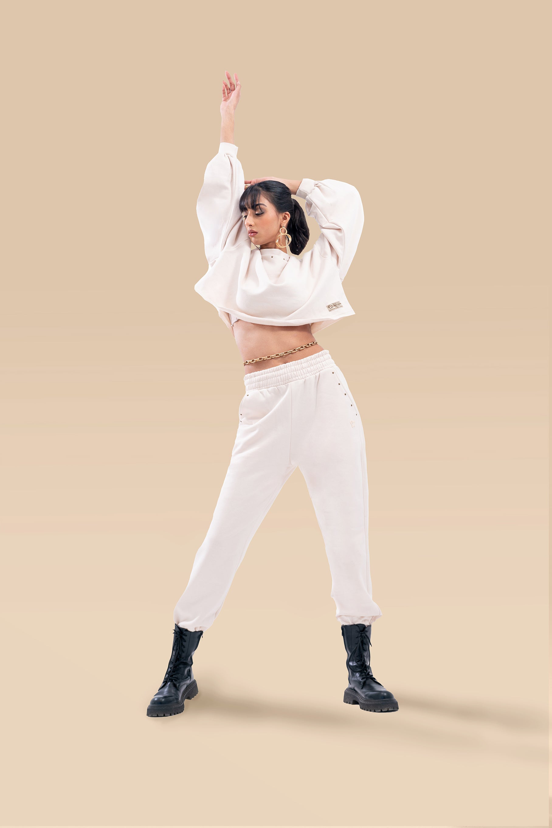  Front view of a stylish cream crop-top and matching high-waist pants co-ord set.