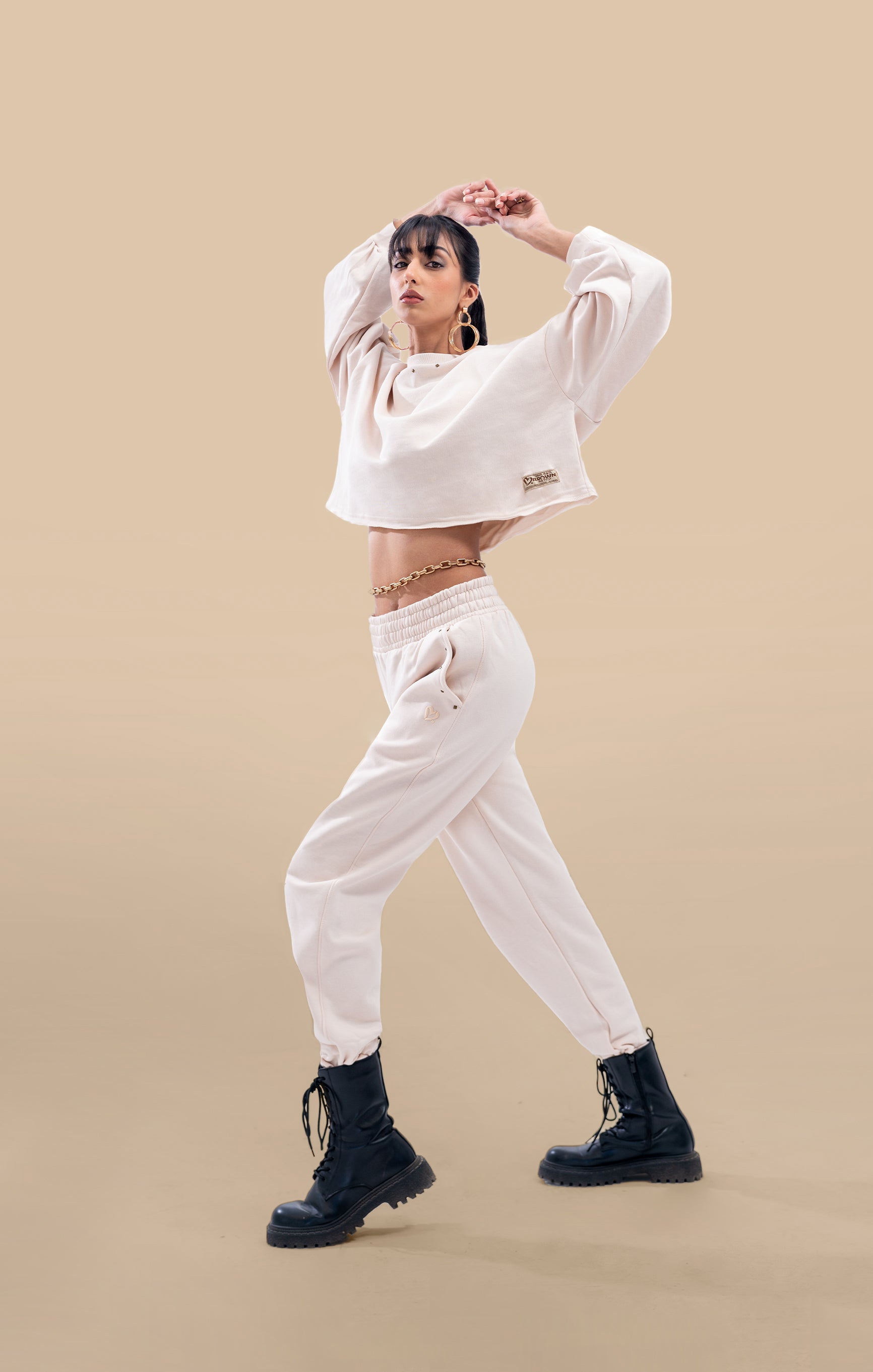  Front view of a stylish cream crop-top and matching high-waist pants co-ord set.