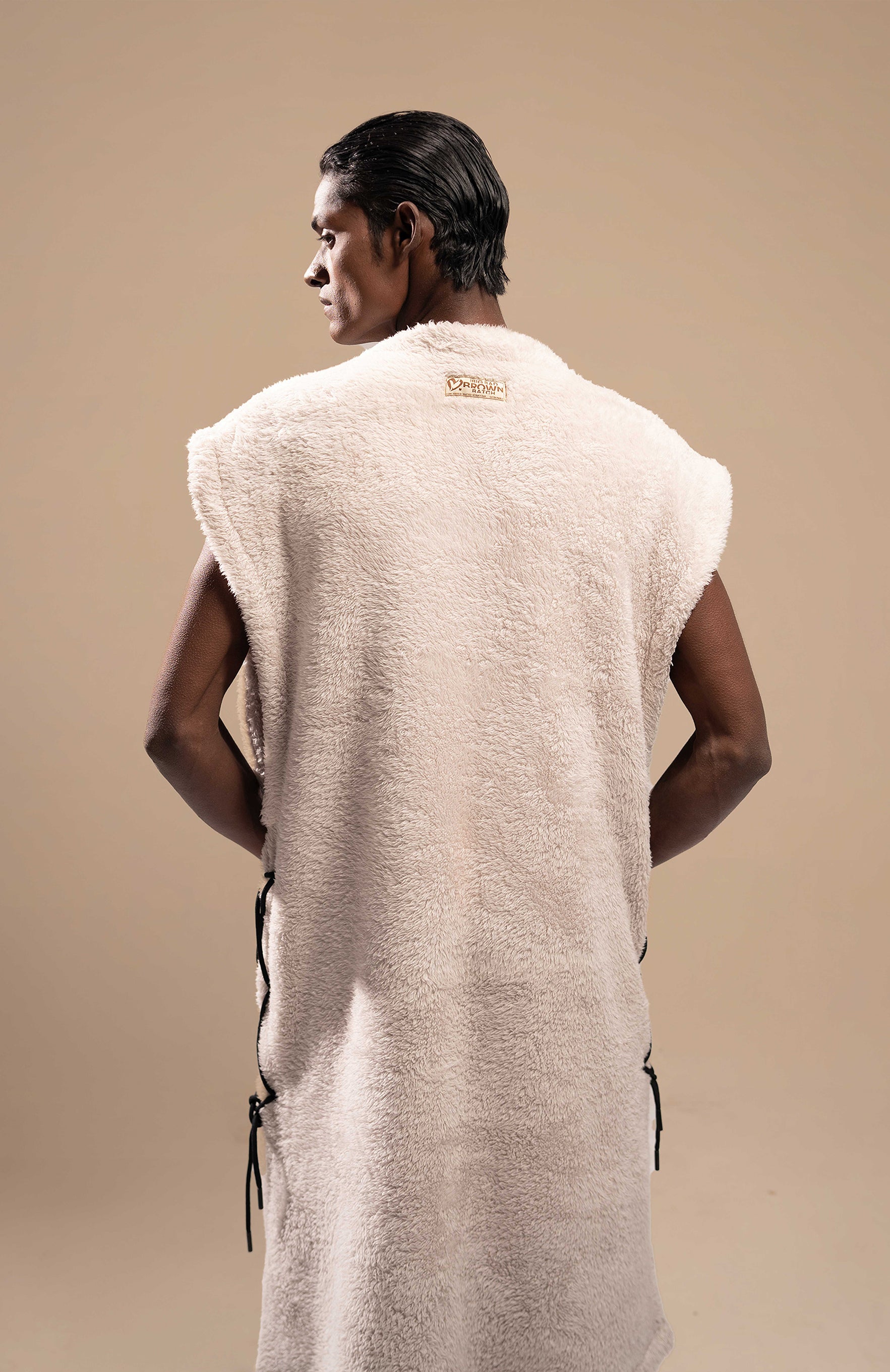  Close-up view of the back of the Plush Comfort Long Sherpa Fur Uni Vest, highlighting the soft sherpa fur and seamless finish.